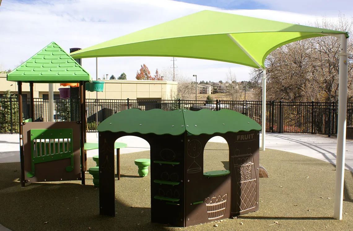 Playground activity stations with shade at Ohana Preschool